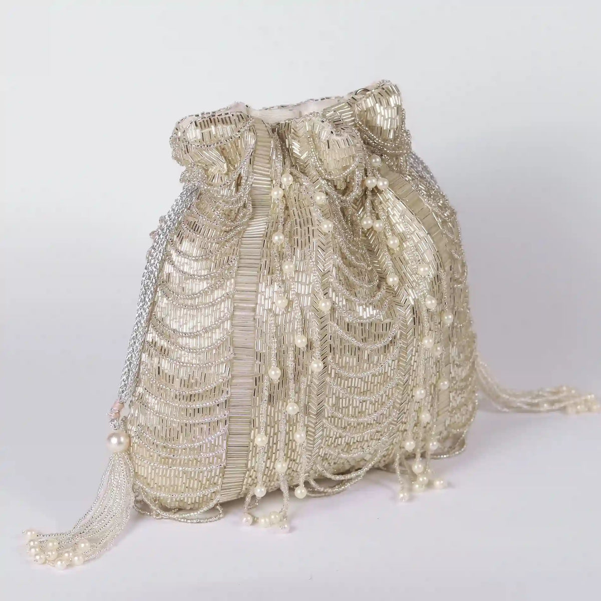 Sharda Potli Bag with handle by The Tan Clan featuring traditional embroidered design and vibrant colors for festive occasions.