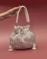 Shubhra Potli bag with handle by The Tan Clan, featuring traditional embroidered design and compact, stylish look.