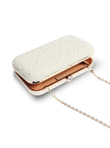 White pearl hand-embroidered clutch bag by The Tan Clan featuring intricate embroidery and a sleek design.