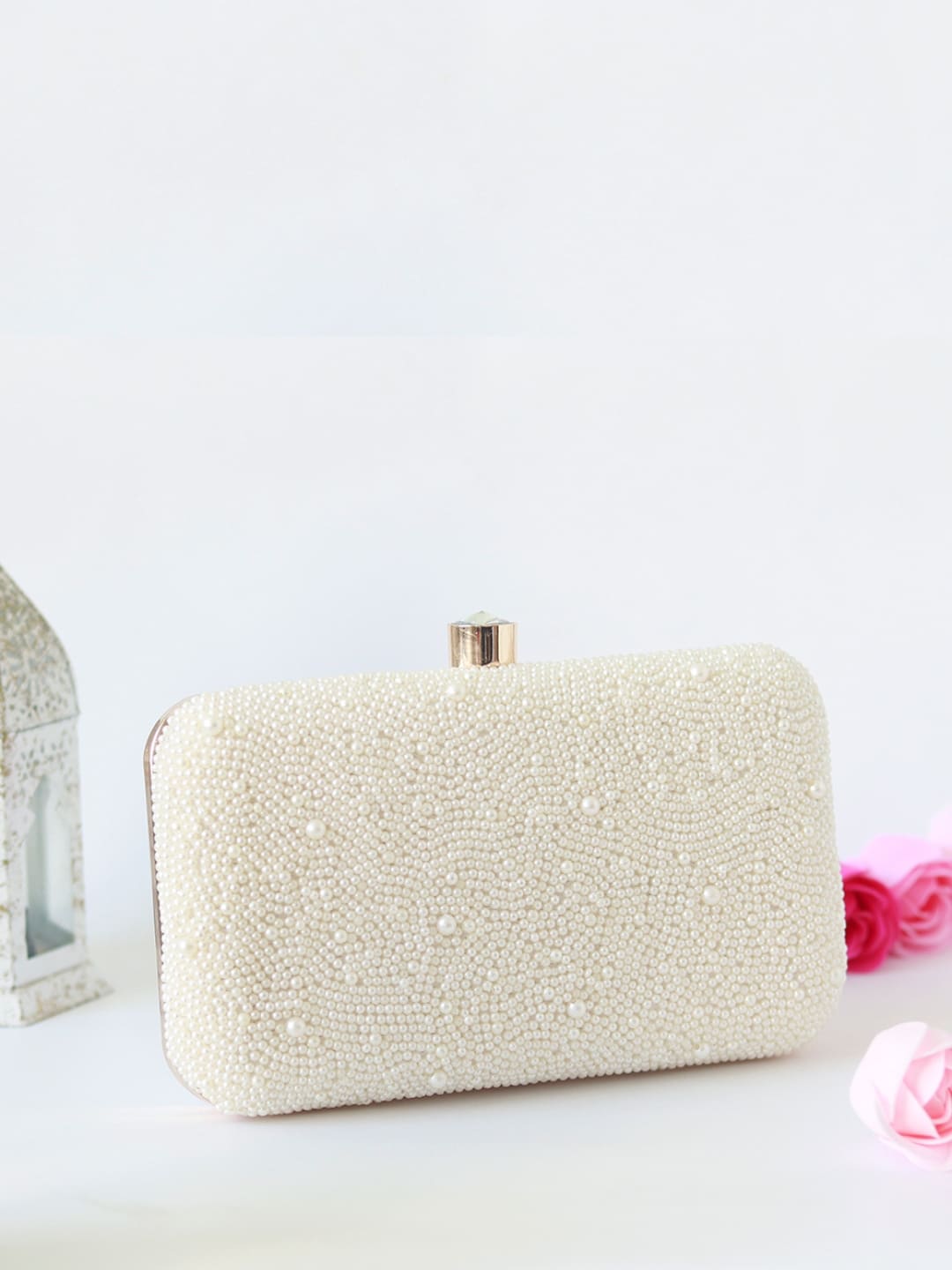 White pearl hand-embroidered clutch by The Tan Clan featuring intricate embroidery and elegant design.