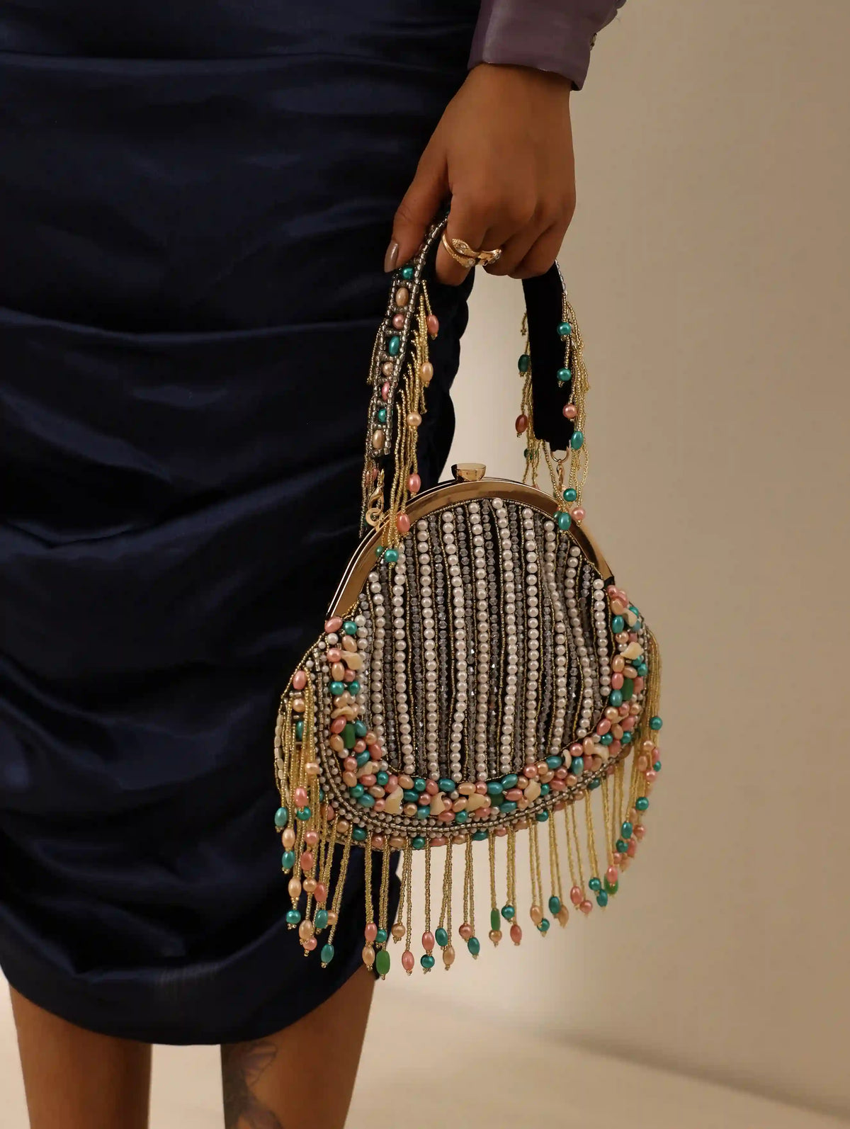Sona Pearl Tasselled Batua with Detachable Handle by The Tan Clan, showcasing a traditional embellished bag with pearl tassels.