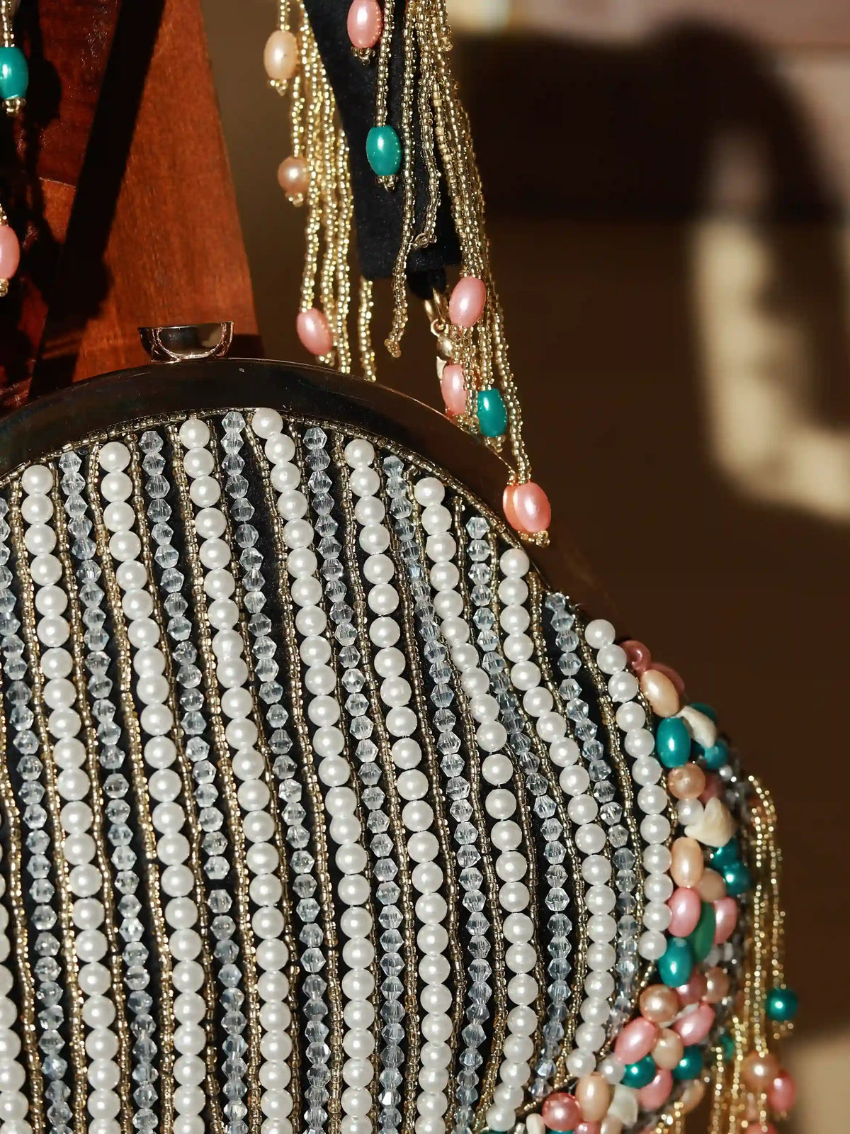 Sona Pearl tasselled Batua bag with detachable handle by The Tan Clan, featuring pearl embellishments and traditional design.
