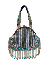 Sona Pearl Tasselled Batua with detachable handle by The Tan Clan, featuring pearl embellishments and tassel details on a traditional bag.