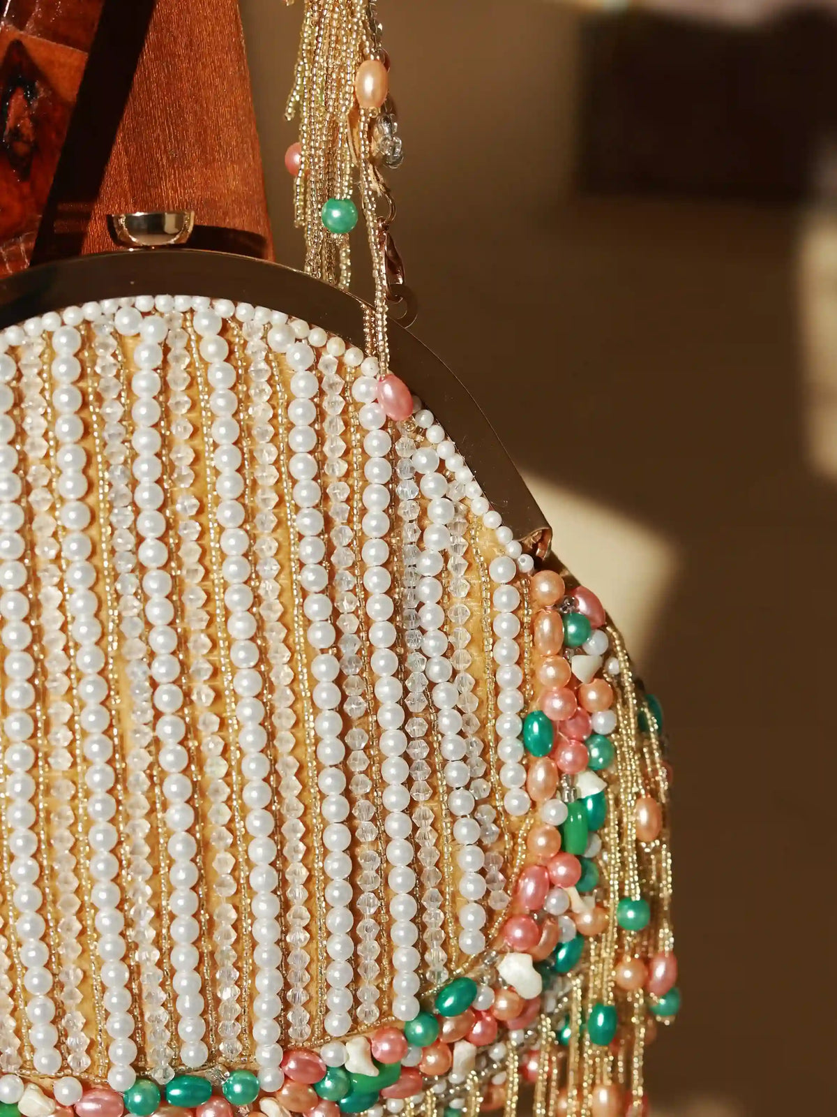 Pearl tasselled Batua bag with detachable handle by The Tan Clan, featuring intricate designs and traditional craftsmanship.
