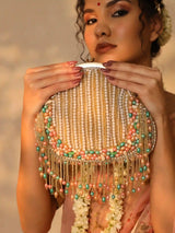 Sona Pearl Tasselled Batua bag by The Tan Clan with a detachable handle and pearl tassel decoration, shown in close-up.