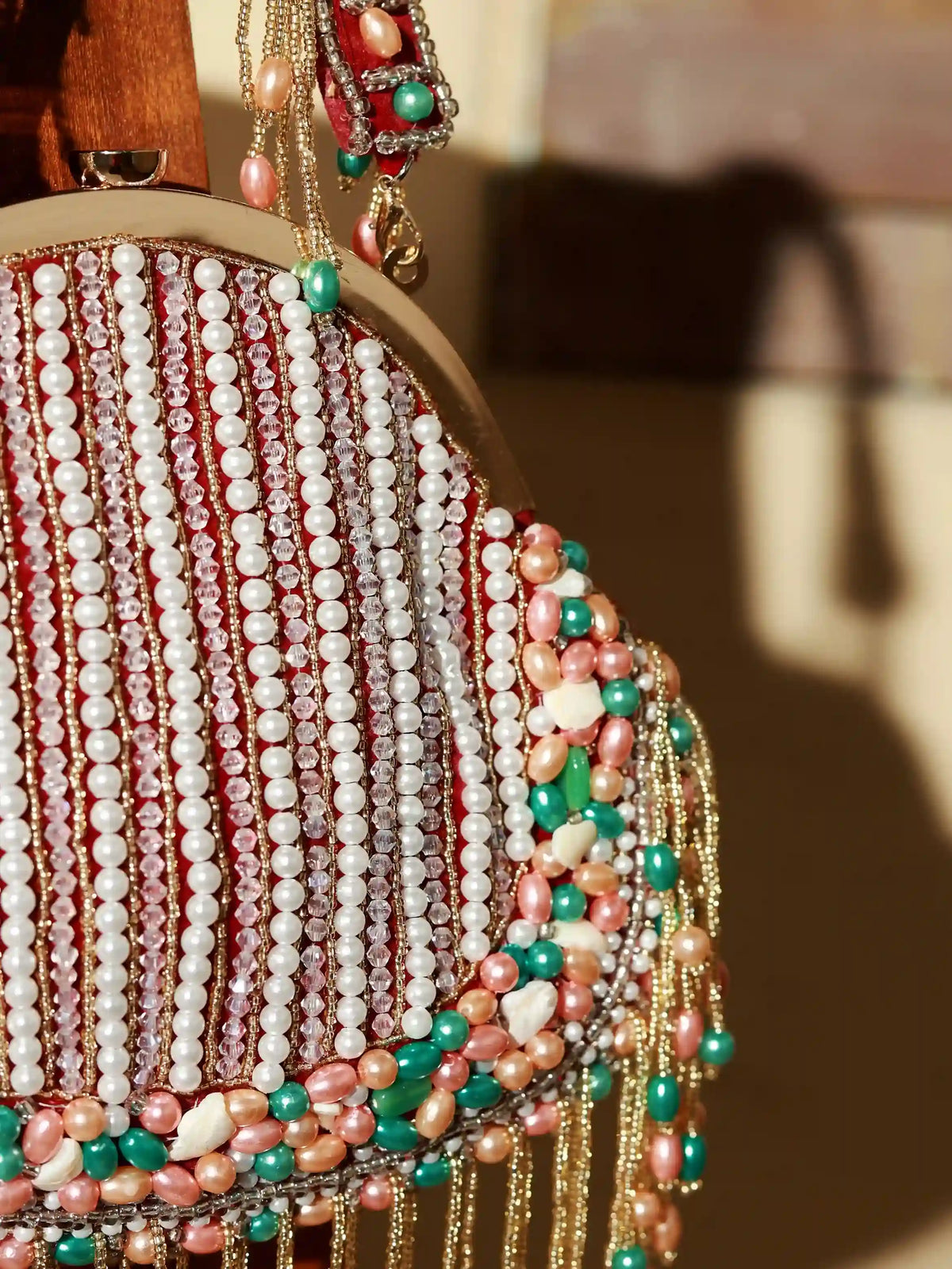 Sona Pearl Tasselled Batua bag with detachable handle by The Tan Clan, featuring pearl embellishments and tassel details.