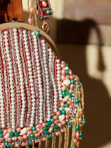 Sona Pearl Tasselled Batua bag with detachable handle by The Tan Clan, featuring pearl embellishments and tassel details.
