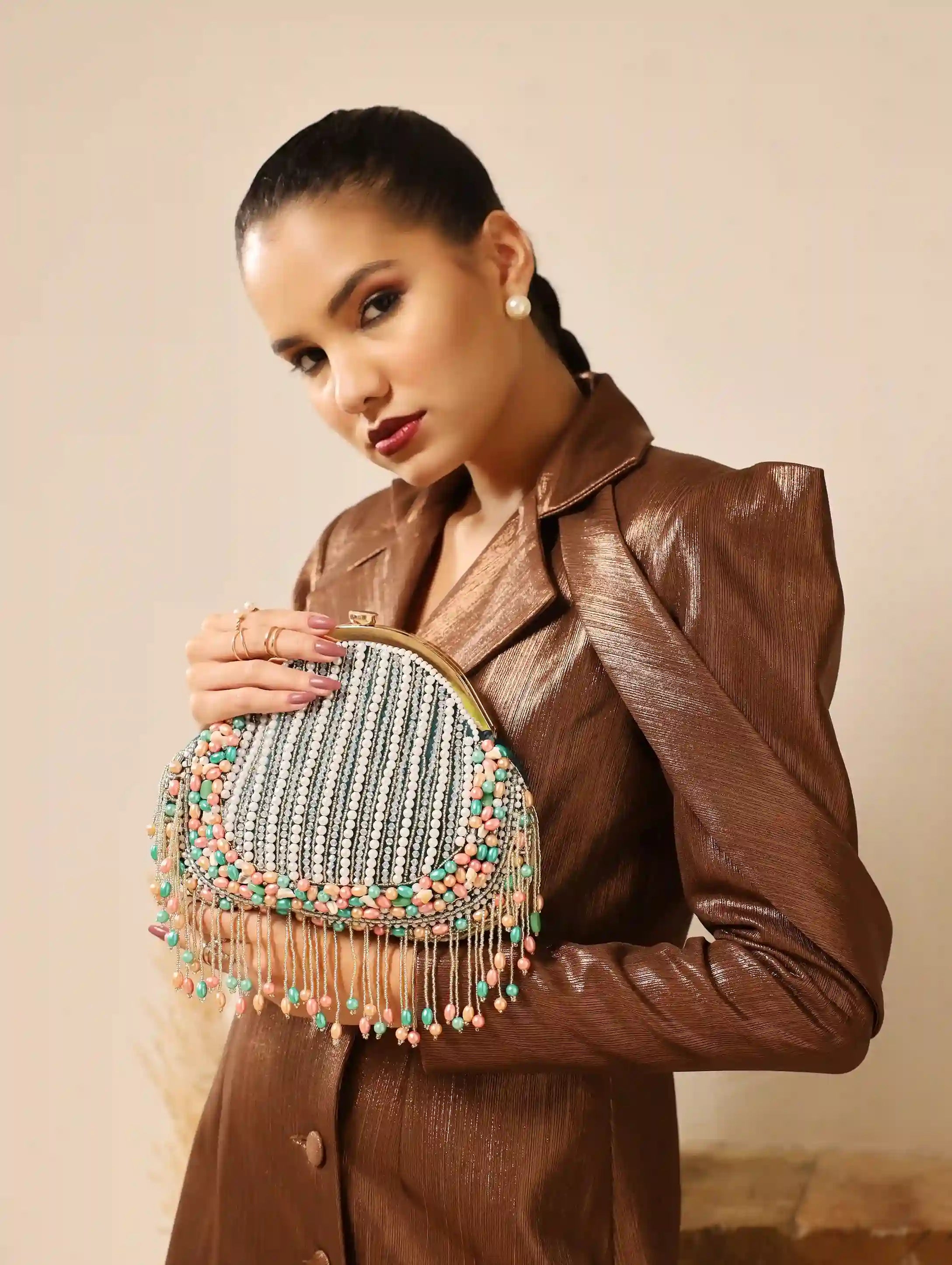 Pearl tasselled batua bag with detachable handle by The Tan Clan, featuring intricate design and traditional craftsmanship.