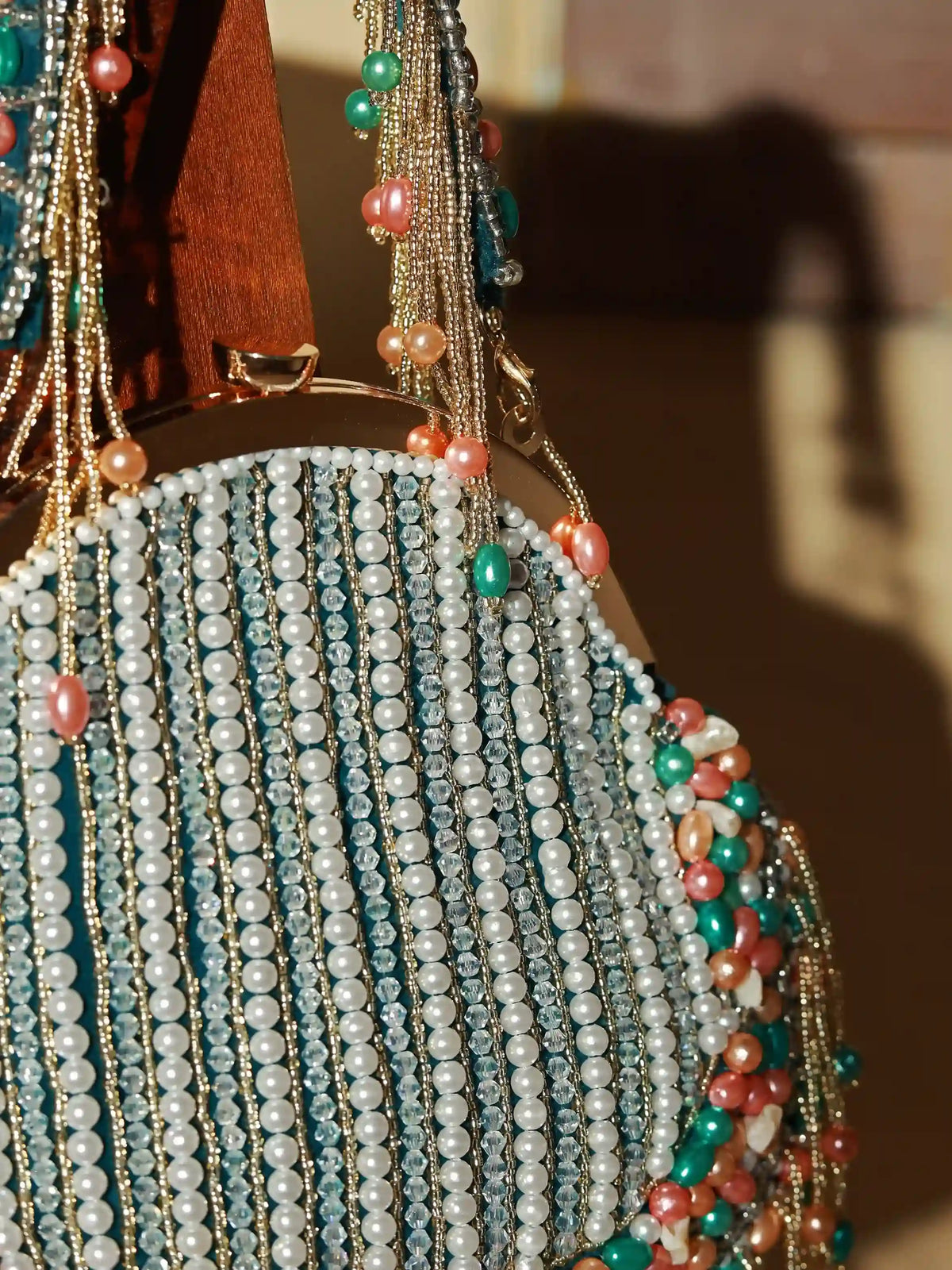 Pearl tasselled batua bag with detachable handle by The Tan Clan, featuring intricate design and elegant craftsmanship.
