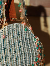 Pearl tasselled batua bag with detachable handle by The Tan Clan, featuring intricate design and elegant craftsmanship.