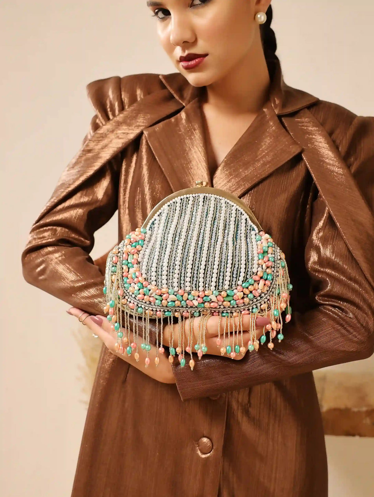 Pearl tasselled Batua handbag with detachable handle by The Tan Clan, featuring intricate design and elegant craftsmanship.