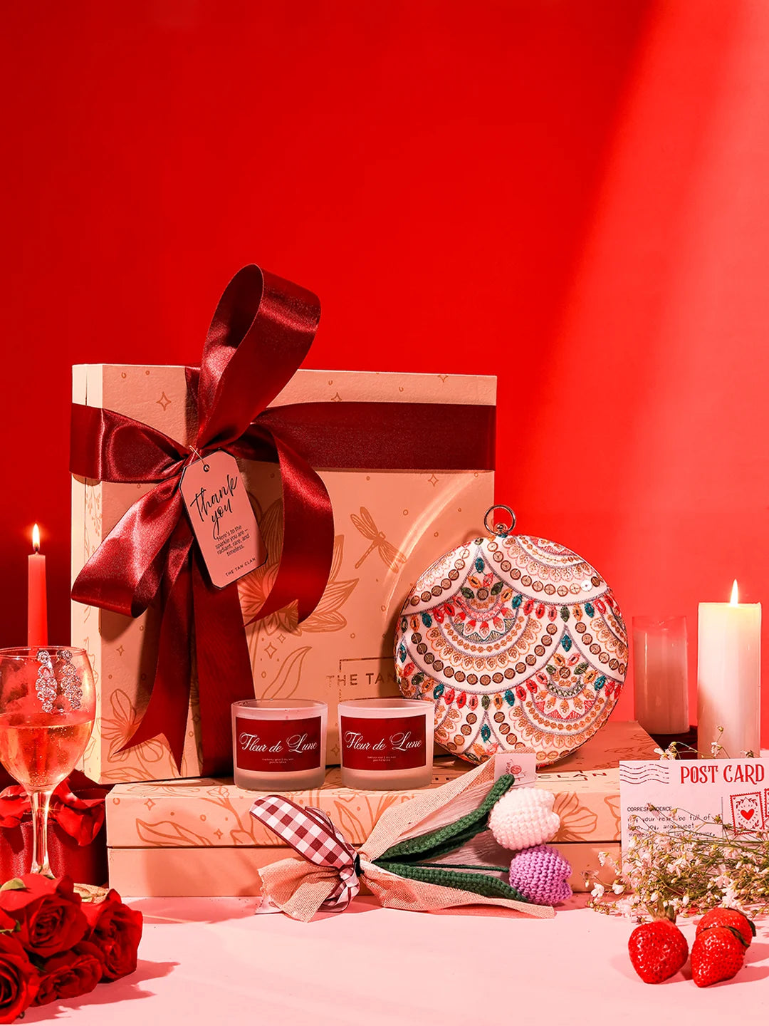 Soul-Care gift set featuring a Jashn clutch, candle, and flower, from THE TAN CLAN, arranged together in the image.