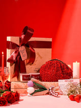 Soul-Care gift set featuring a pink Rosa clutch, candle, and flower arranged together, stylish and elegant for gifting by THE TAN CLAN.