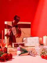 Soul-Care gift set featuring a Taj clutch, candle, and flower with THE TAN CLAN branding, set of three stylish accessories.