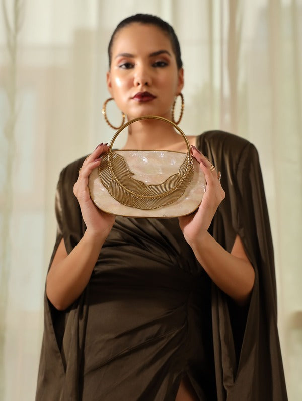 Stella Mother of Pearl Clutch by The Tan Clan featuring iridescent pearl surface and elegant rectangular design.