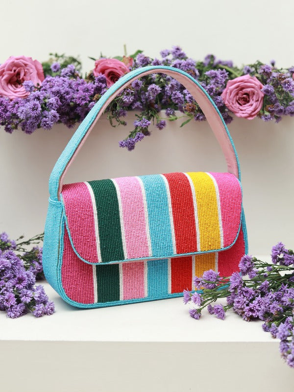Multicolor striped baguette bag with handle by The Tan Clan, featuring a compact design and vibrant color accents.