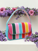Multicolor striped baguette bag with handle by The Tan Clan, featuring a compact design and vibrant color accents.