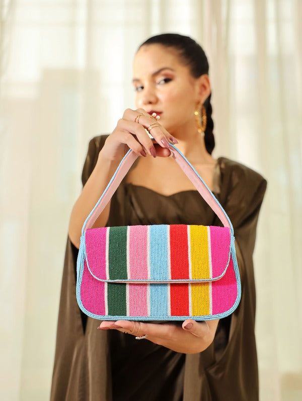Multicolor stripe baguette bag with handle by The Tan Clan, featuring a compact, stylish design with vibrant horizontal stripes.