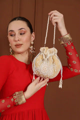 Beige Sukoon hand-embroidered potli bag with pearl handle from The Tan Clan, featuring intricate embroidery and elegant design.