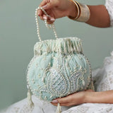 Blue Sukoon hand-embroidered potli bag with pearl handle by The Tan Clan, featuring intricate embroidery and elegant design.