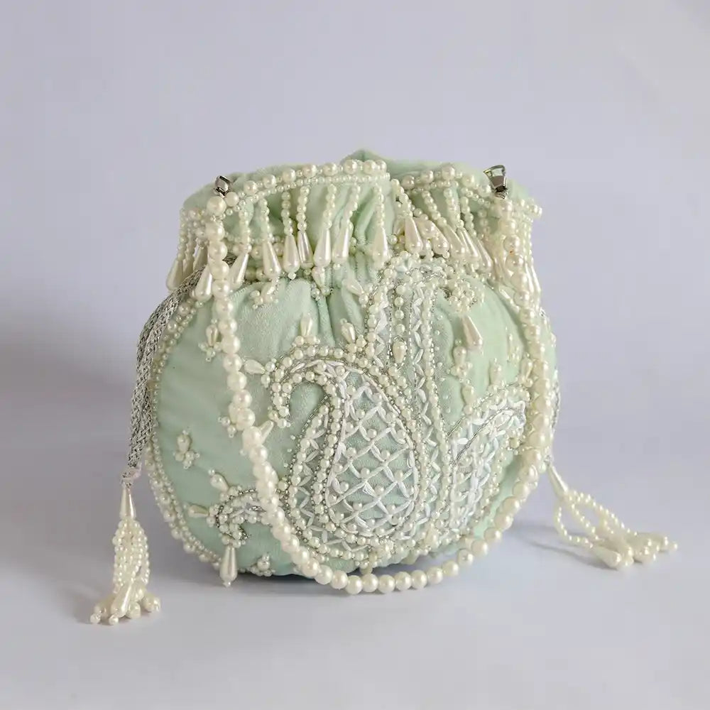 Blue Sukoon hand-embroidered potli bag with pearl handle, crafted by The Tan Clan, featuring intricate embroidery and elegant design.