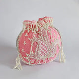 Pink Sukoon hand-embroidered potli bag with pearl handle by The Tan Clan, featuring intricate embroidery and elegant design.