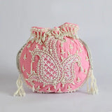 Pink Sukoon hand-embroidered potli bag with pearl handle, featuring intricate embroidery from The Tan Clan.