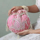 Pink Sukoon hand-embroidered potli bag by The Tan Clan with pearl handle, featuring intricate embroidery and traditional design.