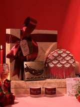 Set of three THE TAN CLAN Sweet Candle Gift Set featuring Irsa clutch, candles, and chocolates arranged together.