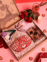 Set of three THE TAN CLAN Sweet-Flower gift sets featuring Elizah clutch bags with flowers and chocolates, perfect for gifting.