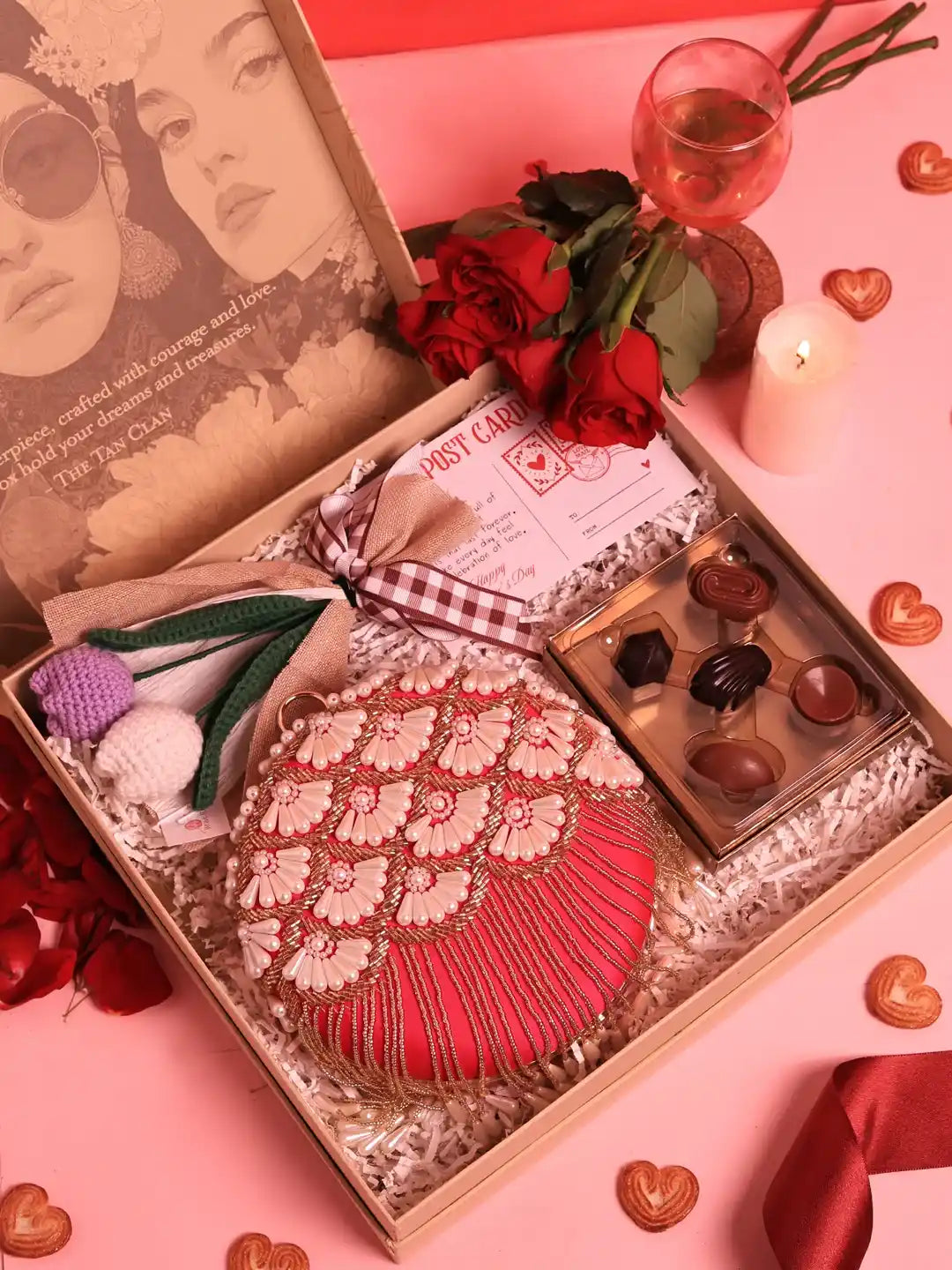Set of three THE TAN CLAN Sweet-Flower Gift Set including Irsa clutch, decorative flower, and chocolates arranged together.