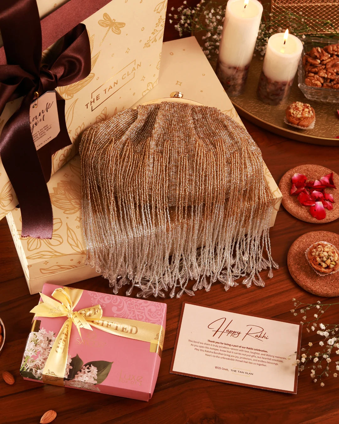 Assorted sweet treats in a gift hamper labeled Sweet Treat Hamper - Amour by The Tan Clan, featuring chocolates and confections.