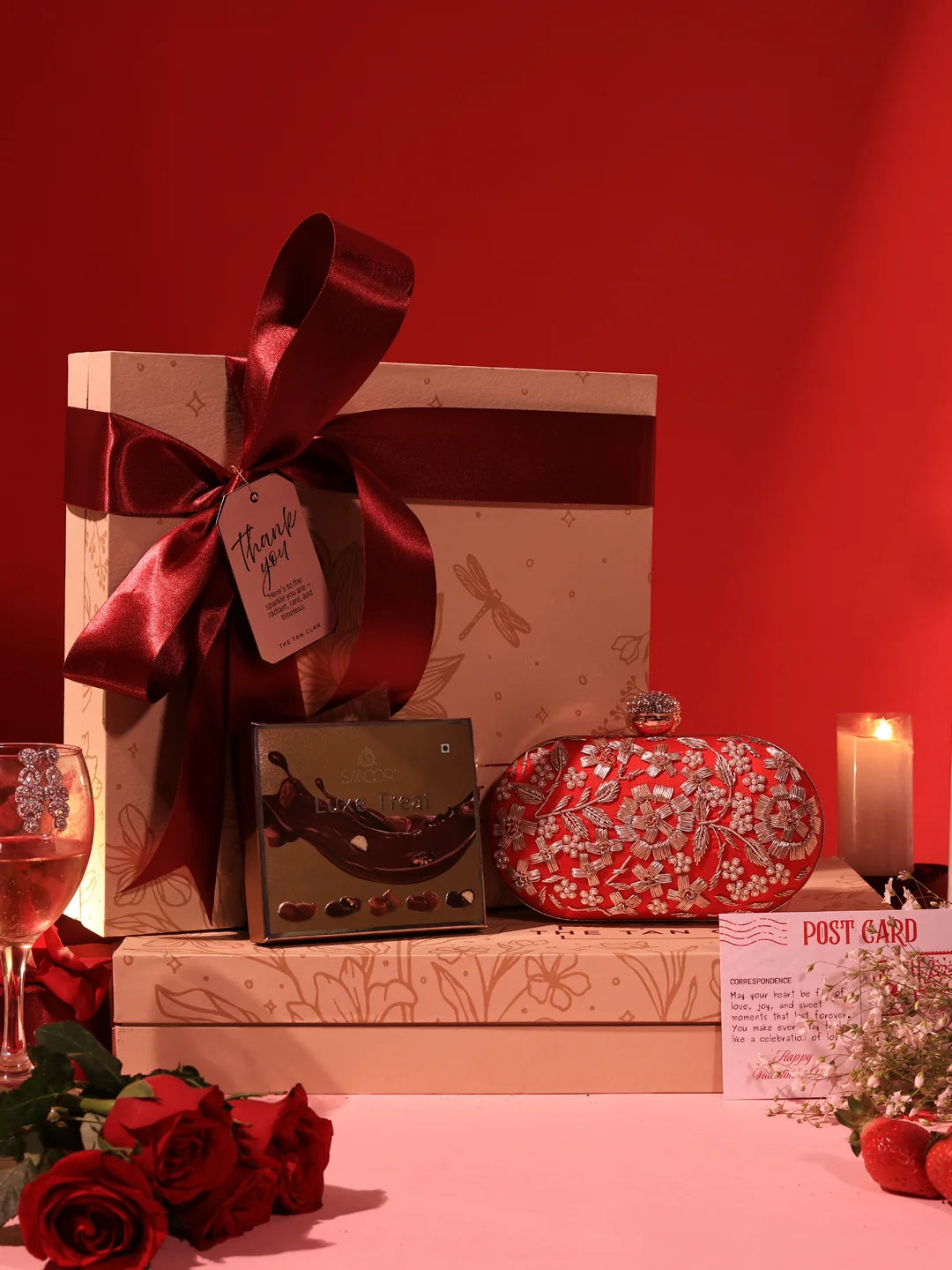 Set of 2 Baiza Clutch sweet treat hampers with chocolates from THE TAN CLAN, featuring elegant clutch designs and assorted chocolates.