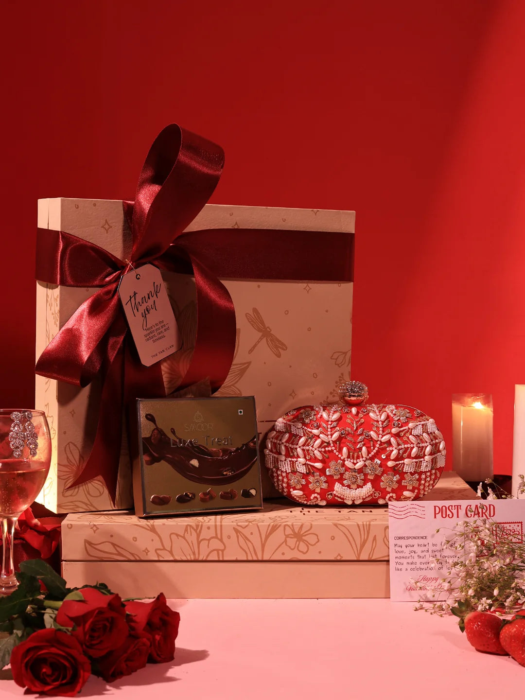 Set of two Elizah Clutch sweet treat hampers from THE TAN CLAN featuring chocolates in elegant packaging.