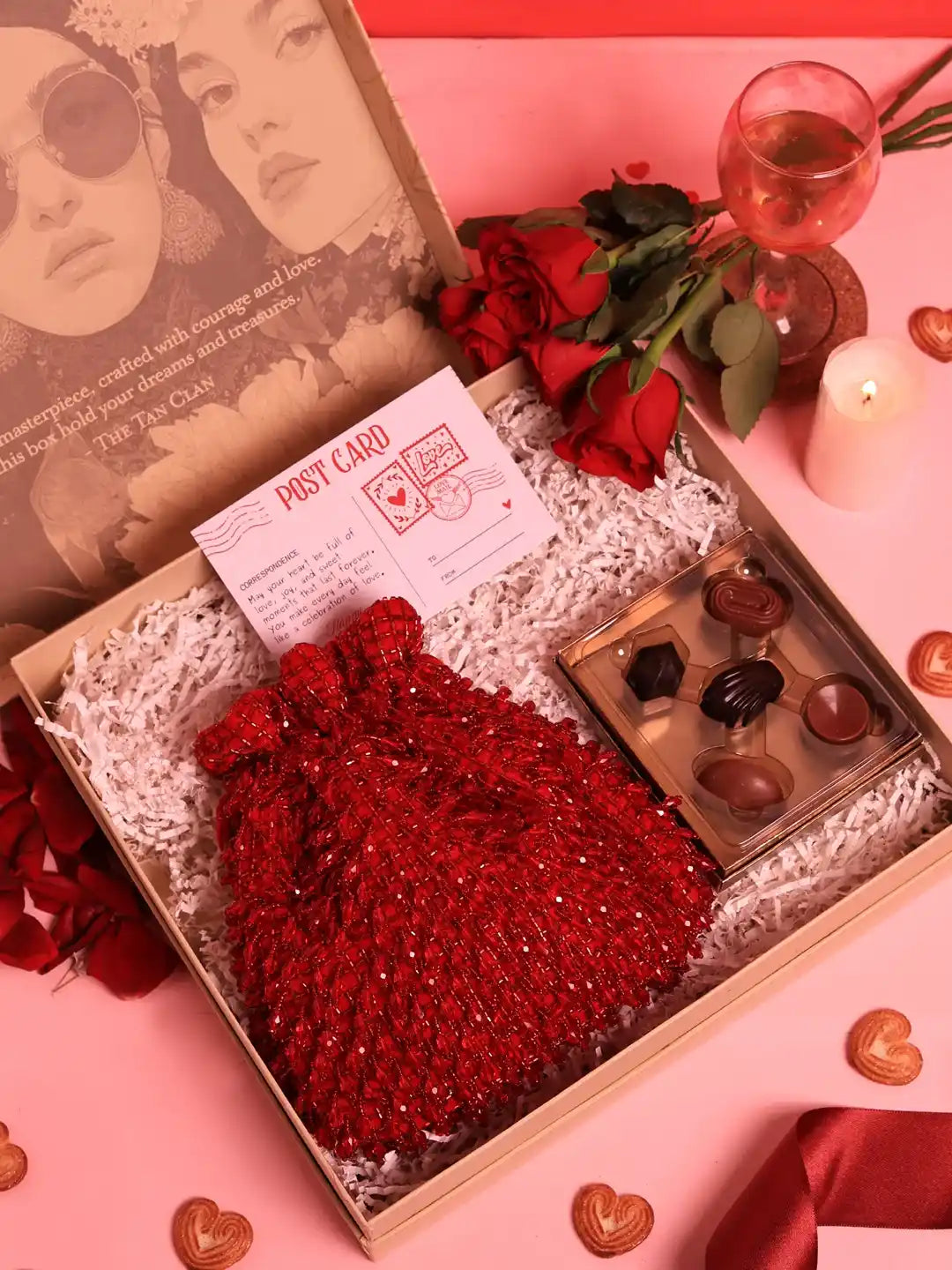 Set of 2 Rosa Potli sweet treat hampers from THE TAN CLAN with chocolates, featuring colorful fabric pouches and assorted confections.