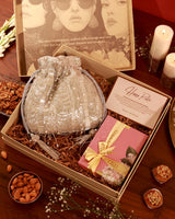 Assorted sweet treats in a gift hamper from The Tan Clan's Sweet Treat Hamper Sharda collection, featuring chocolates and confections.