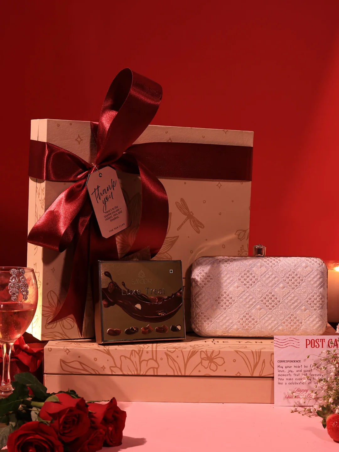 Set of two Taj Clutch sweet treat hampers with chocolates from THE TAN CLAN, featuring elegant packaging and assorted chocolates.