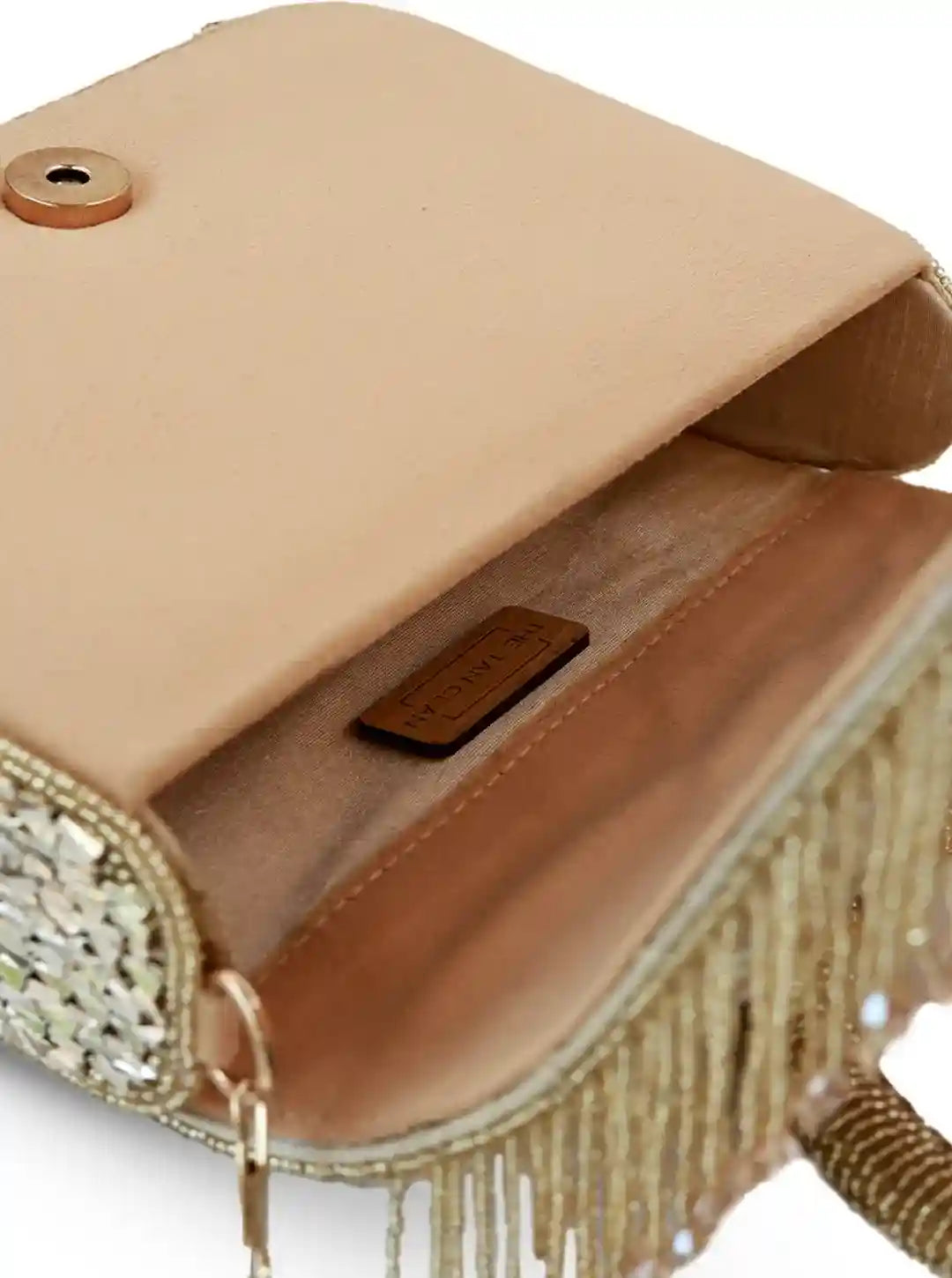 Gold flap-over bag from The Tan Clan featuring a sleek design and structured silhouette, perfect for stylish everyday use.