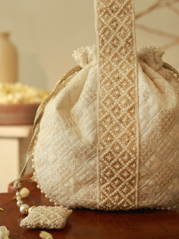 Taj Pearl Potli Bag with Handle by The Tan Clan, featuring intricate pearl embroidery and a traditional design.