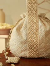 Taj Pearl Potli Bag with Handle by The Tan Clan, featuring intricate pearl embroidery and a traditional design.