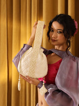 Taj Pearl Potli Bag with Handle by The Tan Clan featuring intricate pearl embroidery and a stylish, traditional design.