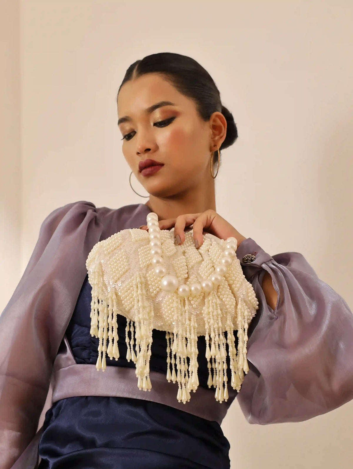 Tara Pearl Tasselled Batua bag by The Tan Clan with detachable handle and intricate pearl embroidery for traditional style.