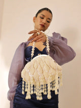 Tara Pearl Tasselled Batua bag with detachable handle by The Tan Clan, featuring pearl embellishments and tassel accents.