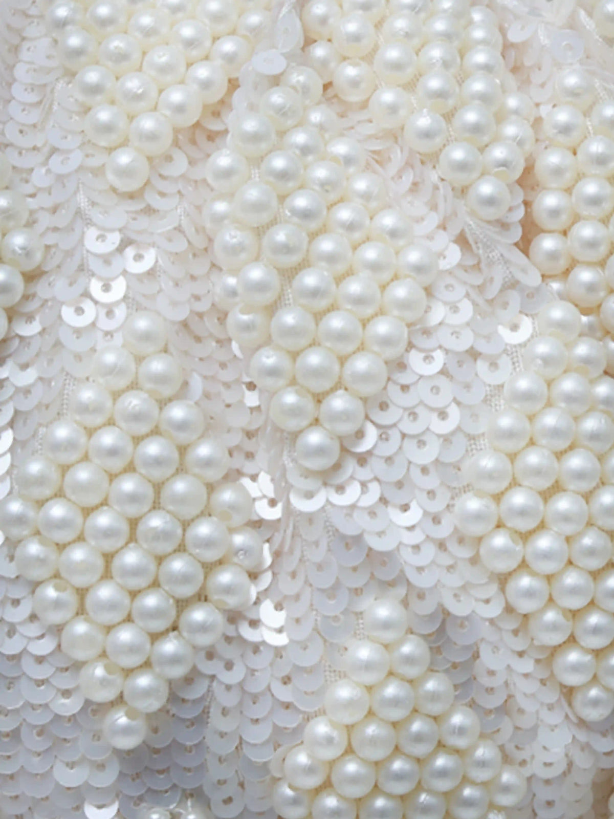 Tara Pearl Tasselled Batua with Detachable Handle by The Tan Clan showing intricate pearl tassel design and detachable strap.