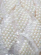 Tara Pearl Tasselled Batua with Detachable Handle by The Tan Clan showing intricate pearl tassel design and detachable strap.