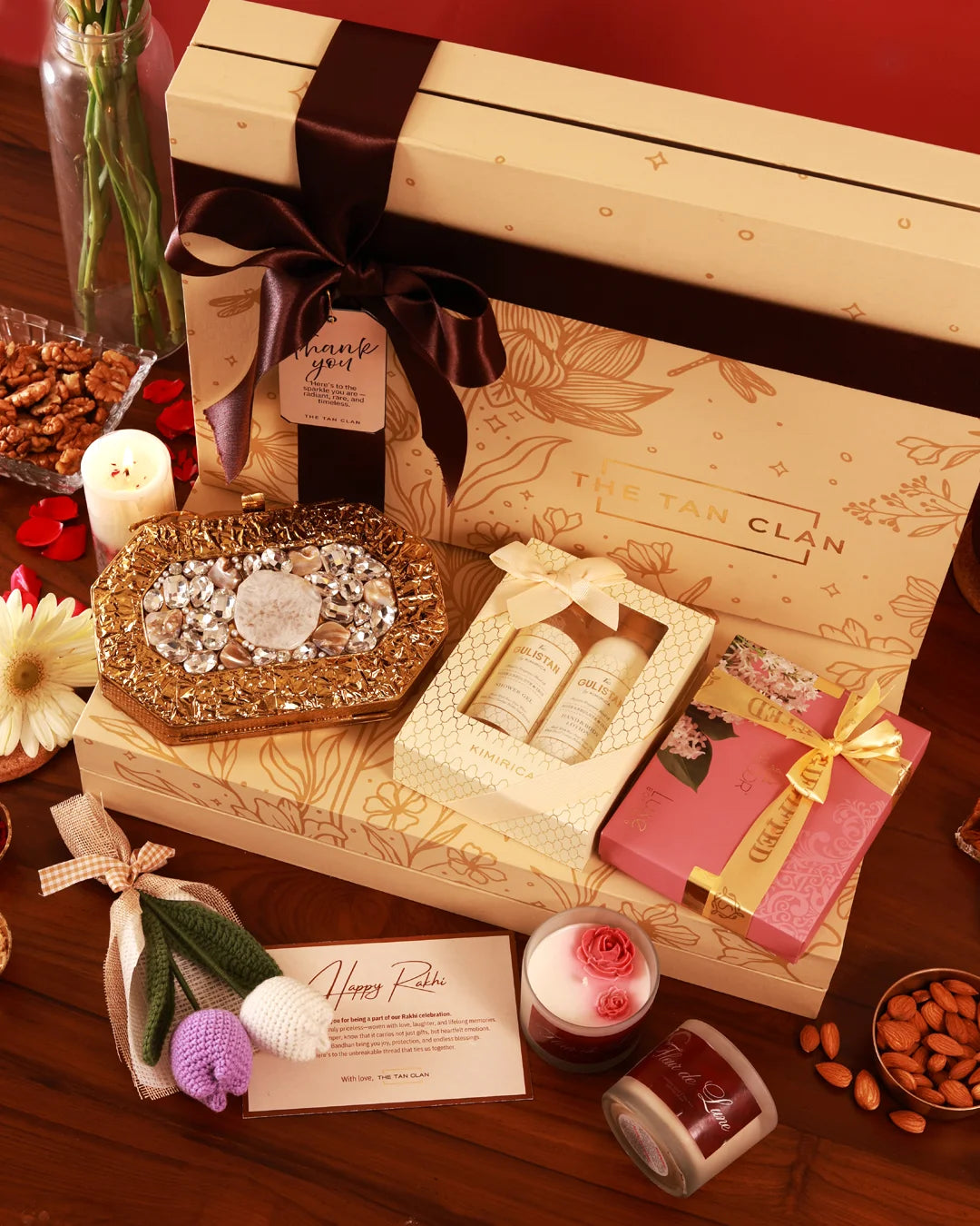 The Tan Clan's Luxe Affair Hamper Burj featuring elegant packaging with luxury skincare and gourmet products inside.