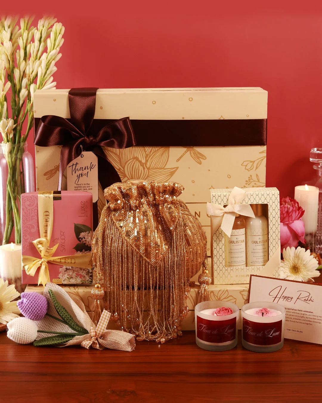The Tan Clan Luxe Affair Hamper Twinkle with luxurious packaging, filled with assorted gourmet treats and elegant accessories inside.
