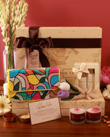 The Luxe Blossom Hamper in Poppy by The Tan Clan featuring a beautifully arranged gift hamper with flowers and luxury items.