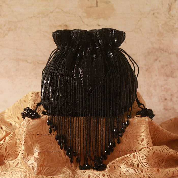 Black Twinkle Heavy Tassles Potli bag with handle by The Tan Clan, featuring intricate tassel detailing and elegant design.