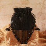 Black Twinkle Heavy Tassles Potli bag with handle by The Tan Clan, featuring intricate tassel detailing and elegant design.